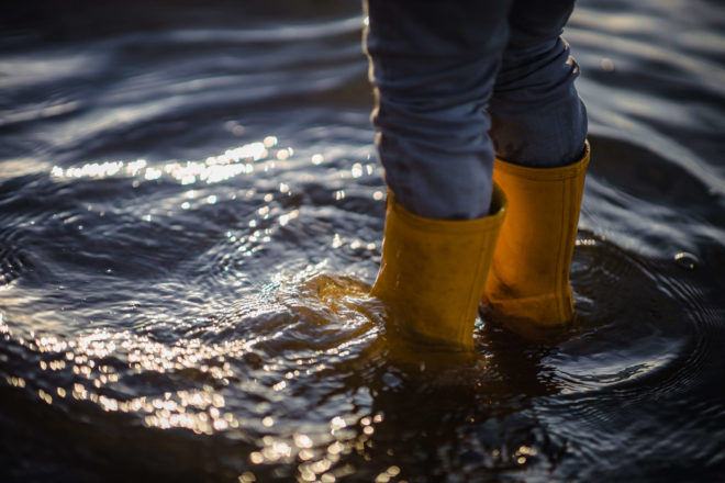 Photo of someone standing in flood water