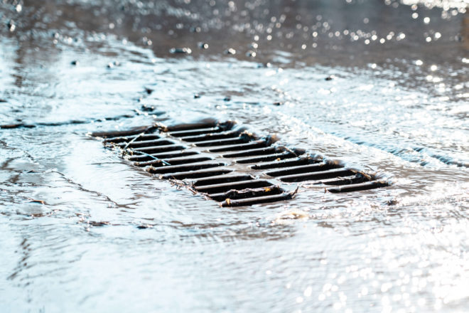 Photo of stormwater going down a street drain