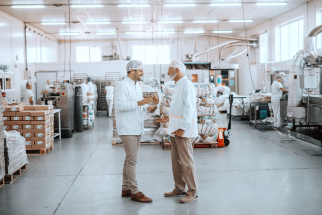 Commercial kitchen with two chefs and equipment